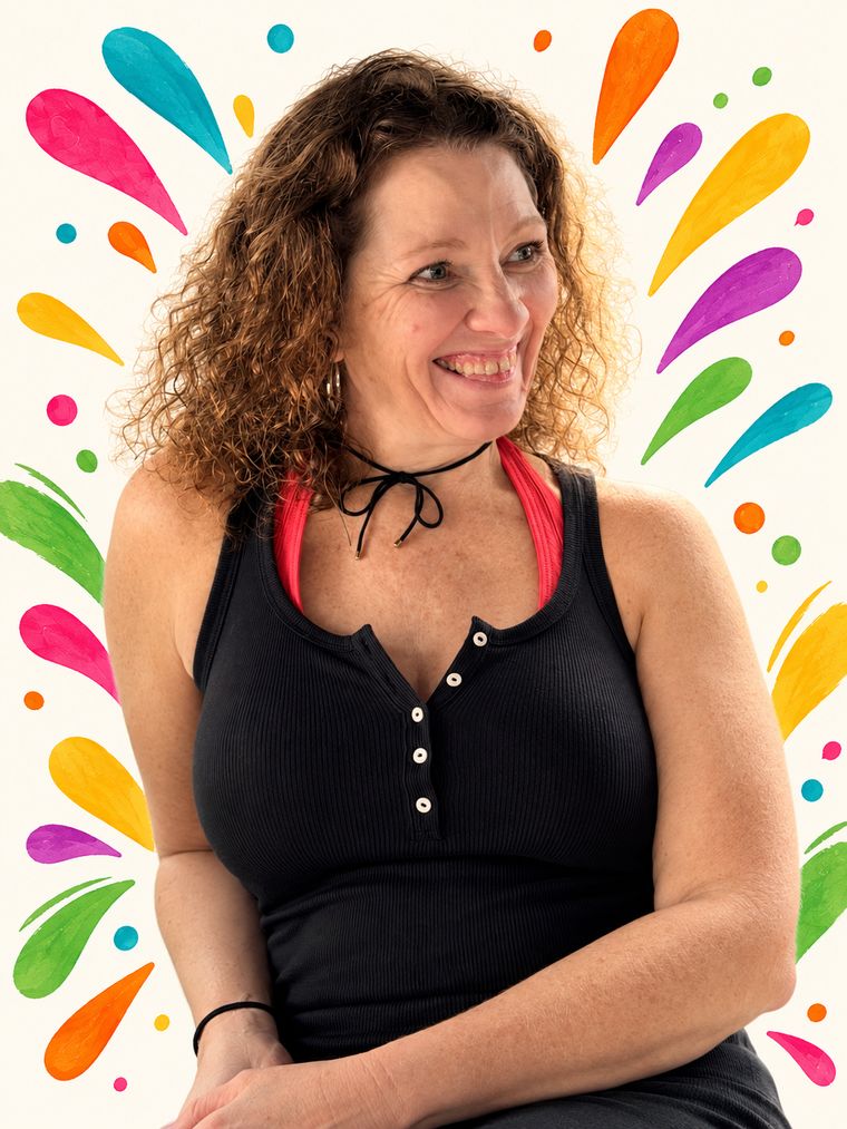 Tabitha smiling, surrounded by colorful paint splashes